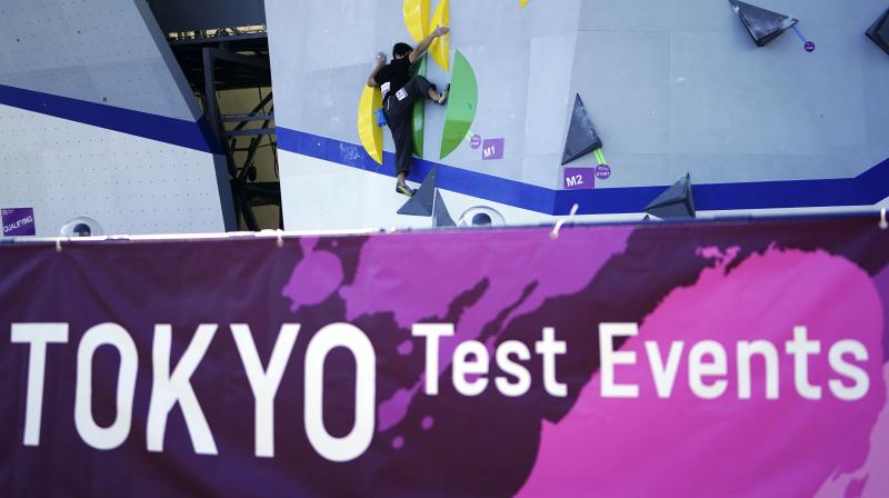 A Tokyo 2020 Olympic Games Organizing staff climbs the wall in the test event of Speed Climbing in preparation for the Tokyo 2020 Olympic Games at Aomi Urban Sports Park in Tokyo last week. AP Photo