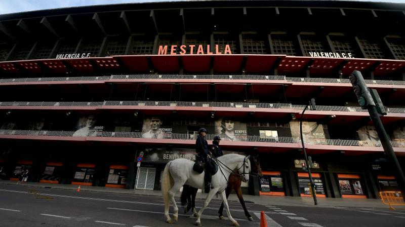 Mounted Spanish policemen patrol outside the Mestalla stadium in Valencia on March 10, 2020 before the UEFA Champions League round of 16 second leg  football match between Valencia and Atalanta that will be played behind closed doors due to the coronavirus outbreak. - Football matches in the top two divisions in Spain and France will be played behind closed doors for at least the next two weeks following the decision by Italys government to suspend top-flight games until April 3 due to the coronavirus epidemic. (Photo by JOSE JORDAN / AFP