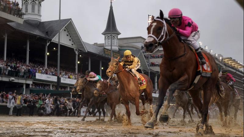 In this May 4, 2019, file photo, Luis Saez rides Maximum Security (R) across the finish line first against Flavien Prat on Country House during the 145th running of the Kentucky Derby at Churchill Downs in Louisville, Kentucky. AP Photo