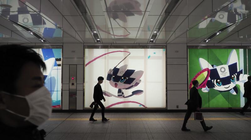 Large displays promoting the Tokyo 2020 Olympics are erected all oin Tokyo, Friday, March 13, 2020. U.S. President Donald Trumps suggestion to postpone the Tokyo Olympics for a year because of the spreading coronavirus was immediately shot down by Japans Olympic minister. For most people, the new coronavirus causes only mild or moderate symptoms. For some it can cause more severe illness. (AP