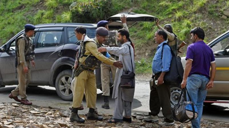 Security personnel frisking the yatris and locals before they head towards the holy cave shrine following the militant attack on a bus in which seven pilgrims were killed and 19 others injured, at Nuwun base Camp in South Kashmir on Monday. (Photo: PTI) Security personnel frisking the yatris and locals before they head towards the holy cave shrine following the militant attack on a bus in which seven pilgrims were killed and 19 others injured, at Nuwun base Camp in South Kashmir on Monday. (Photo: PTI)