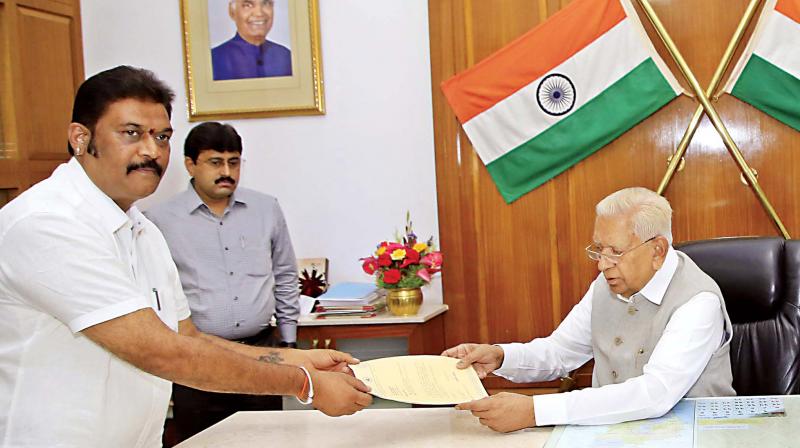 Congress MLA Anand Singh hands over his resignation letter to Governor Vajubhai Vala in Bengaluru on Monday Congress MLA Anand Singh hands over his resignation letter to Governor Vajubhai Vala in Bengaluru on Monday