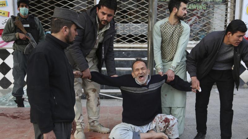 A relative of a victim is helped as he cries after a deadly suicide attack in Kabul. (Photo: AP) A relative of a victim is helped as he cries after a deadly suicide attack in Kabul. (Photo: AP)