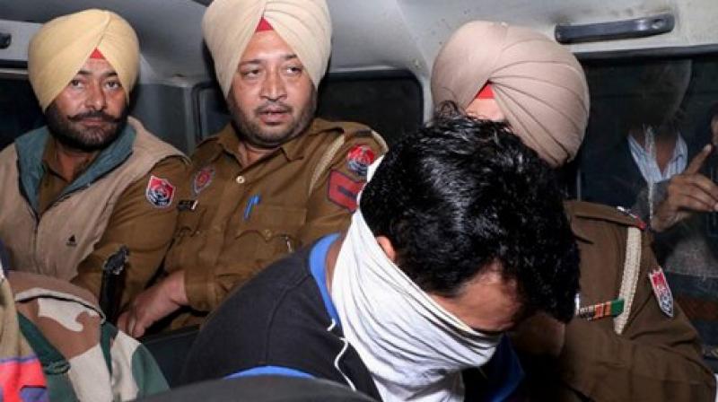 Police take an accused to the court at Nabha on Wednesday in connection with the Nabha jail break case. (Photo: PTI) Police take an accused to the court at Nabha on Wednesday in connection with the Nabha jail break case. (Photo: PTI)