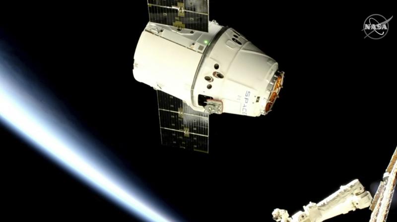 Canadian astronaut David Saint-Jacques used the station’s big robot arm — also made in Canada — to capture the Dragon approximately 250 miles (400 kilometers) above the North Atlantic Ocean. An external cable that normally comes off during launch dangled from the capsule, but it did not interfere with the grappling. (Photo: AP) Canadian astronaut David Saint-Jacques used the station’s big robot arm — also made in Canada — to capture the Dragon approximately 250 miles (400 kilometers) above the North Atlantic Ocean. An external cable that normally comes off during launch dangled from the capsule, but it did not interfere with the grappling. (Photo: AP)