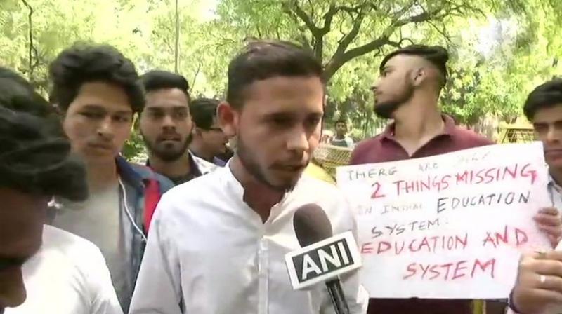 Raising slogan ‘we want justice’, the protesting students said, 'either there should re-examinations of all subjects or else of neither.' (Photo: Twitter | ANI) Raising slogan ‘we want justice’, the protesting students said, 'either there should re-examinations of all subjects or else of neither.' (Photo: Twitter | ANI)