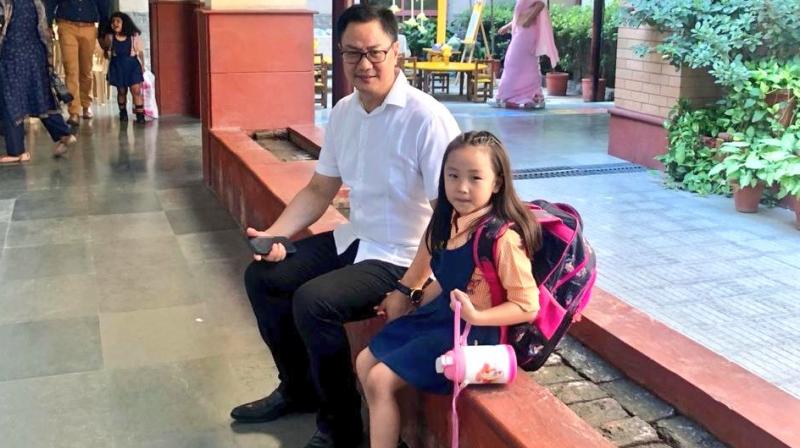 Minister of State for Home Affairs Kiren Rijiju is seen sitting on a ledge in the school corridor with his daughter all elated. (Photo: Twitter | @KirenRijiju) Minister of State for Home Affairs Kiren Rijiju is seen sitting on a ledge in the school corridor with his daughter all elated. (Photo: Twitter | @KirenRijiju)