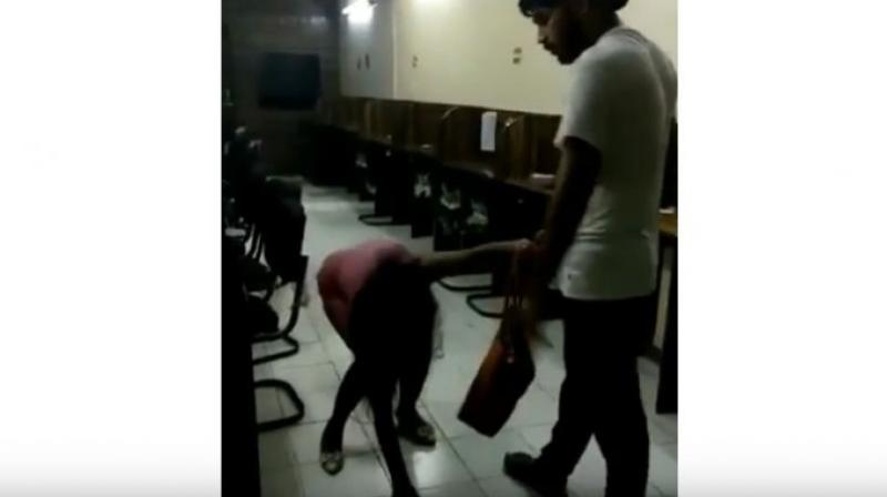 Rohit Tomar was seen brutally thrashing and kicking the woman with his knees and dragging her by her hair as she pleads for mercy. (Photo: YouTube | Screengrab) Rohit Tomar was seen brutally thrashing and kicking the woman with his knees and dragging her by her hair as she pleads for mercy. (Photo: YouTube | Screengrab)