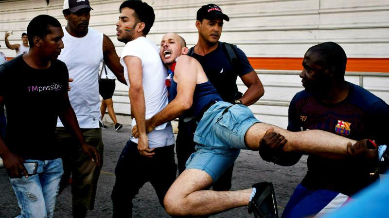 Cuban police detain a gay rights activist taking part in an unauthorized march in Havana, Cuba. (Photo: AP) Cuban police detain a gay rights activist taking part in an unauthorized march in Havana, Cuba. (Photo: AP)