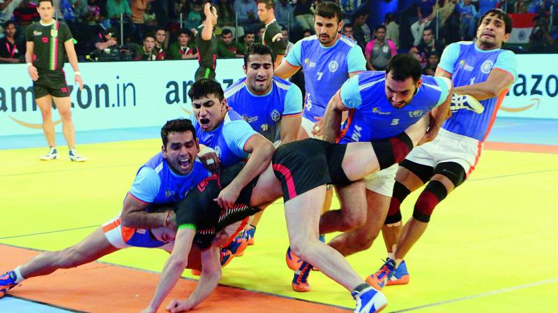 Indian players trap an Iranian raider during the kabaddi World Cup final in Ahmedabad on Saturday. Indian players trap an Iranian raider during the kabaddi World Cup final in Ahmedabad on Saturday.