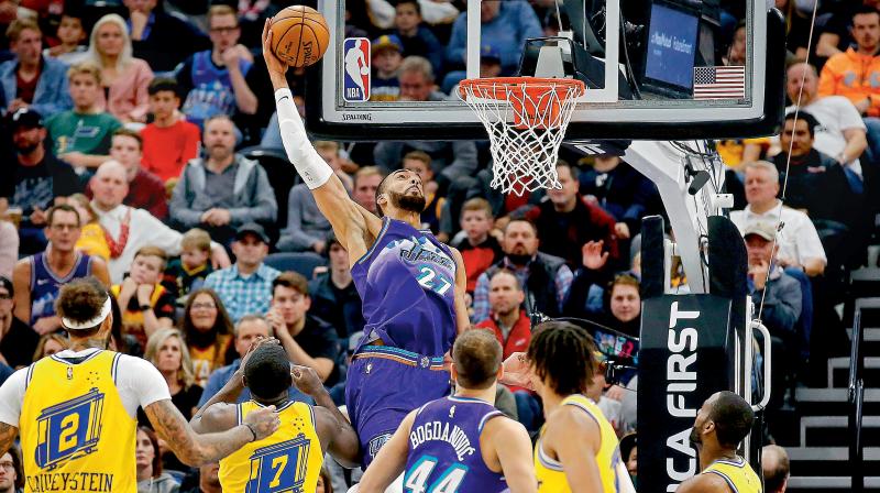 Utah Jazz center Rudy Gobert (27) scores against the Golden State Warriors. AP Photo