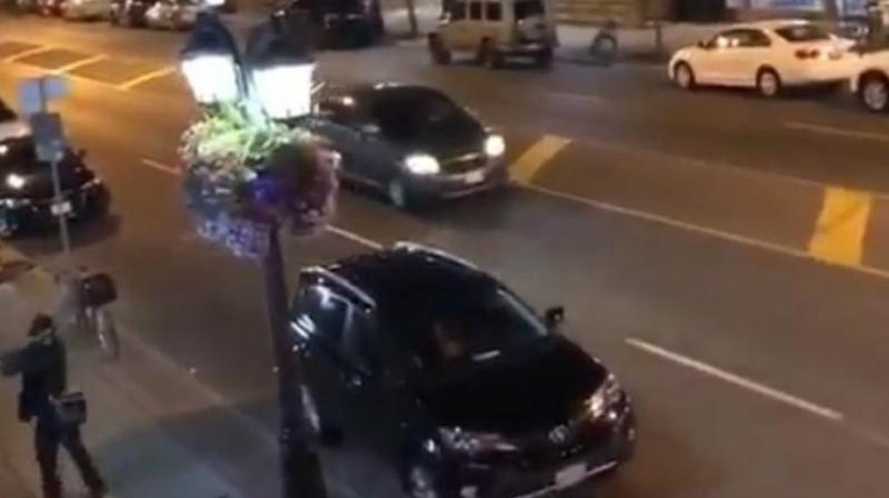 The video from a witness shows the man dressed in black clothes and a black hat walking quickly and firing three shots from the sidewalk into at least one shop or restaurant. (Photo: Video screengrab | Twitter/@TheAPJournalist) The video from a witness shows the man dressed in black clothes and a black hat walking quickly and firing three shots from the sidewalk into at least one shop or restaurant. (Photo: Video screengrab | Twitter/@TheAPJournalist)