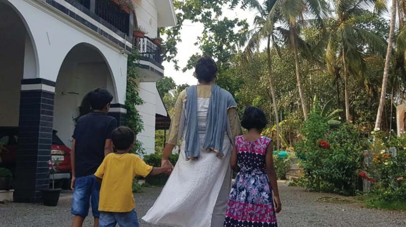 A parent with the adopted girl under foster care programme with two of her biological children at her house in Malappuram A parent with the adopted girl under foster care programme with two of her biological children at her house in Malappuram