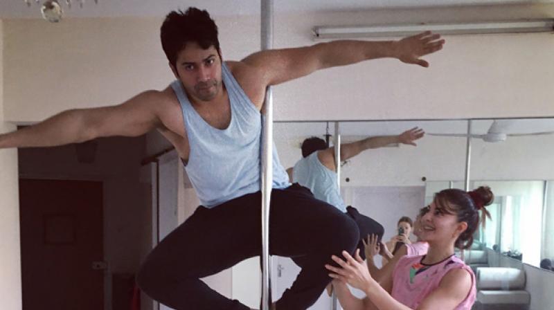 Varun Dhawan with Jacqueline Fernandez during their pole dancing practice! Varun Dhawan with Jacqueline Fernandez during their pole dancing practice!