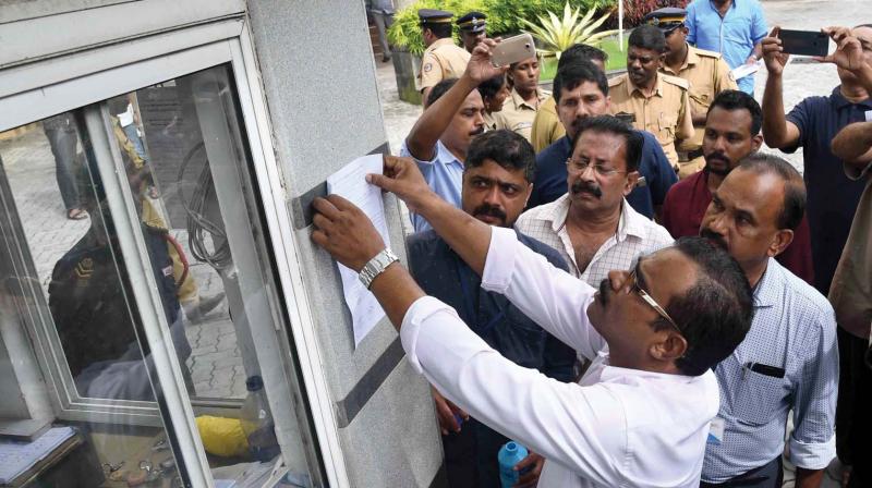 Maradu Municipal officials stick eviction notice at Alfa Serene flat in Kochi on Tuesday. (Photo: DC) Maradu Municipal officials stick eviction notice at Alfa Serene flat in Kochi on Tuesday. (Photo: DC)