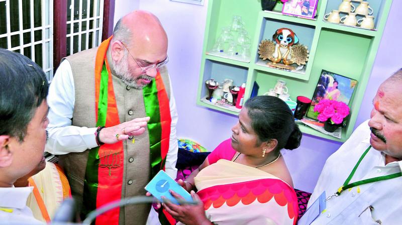 BJP national president Amit Shah visits a beneficiary house of PMAY at 47th division in Rajahmundry on Thursday. AP State President K.Lakshmi Narayana and Rajya Sabha member G.V.L.Narasimha Rao are seen. BJP national president Amit Shah visits a beneficiary house of PMAY at 47th division in Rajahmundry on Thursday. AP State President K.Lakshmi Narayana and Rajya Sabha member G.V.L.Narasimha Rao are seen.