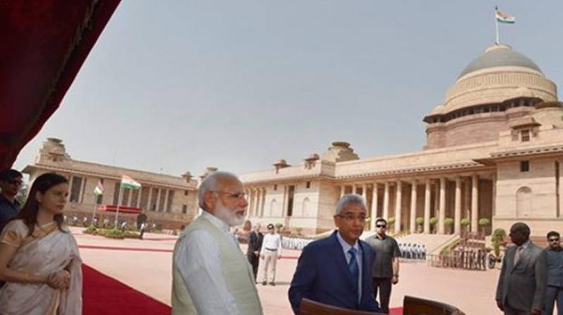 Mauritian PM Pravind Kumar Jugnauth addresses media as his wife Kobita Jugnauth and Prime Minister Narendra Modi look on during the ceremonial reception at the forecourt of Rashtrapati Bhawan in New Delhi on Saturday. (Photo: PTI) Mauritian PM Pravind Kumar Jugnauth addresses media as his wife Kobita Jugnauth and Prime Minister Narendra Modi look on during the ceremonial reception at the forecourt of Rashtrapati Bhawan in New Delhi on Saturday. (Photo: PTI)