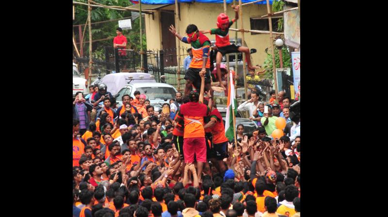 Mumbai youth form a human pyramid to break the Dahi Handi to mark the Janmashtami festival. (Photo: Debasish Dey) Mumbai youth form a human pyramid to break the Dahi Handi to mark the Janmashtami festival. (Photo: Debasish Dey)