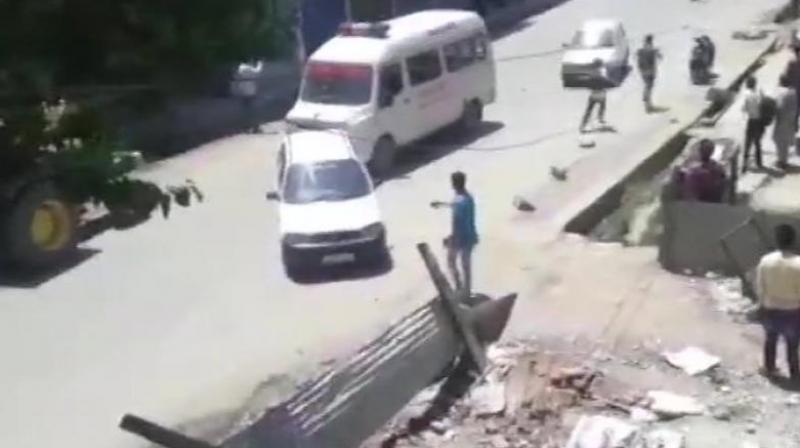 Militants hurled a grenade on security forces in Shopian town, resulting in injuries to at least 12 civilians and four cops, a police official said. (Photo: Twitter/ANI) Militants hurled a grenade on security forces in Shopian town, resulting in injuries to at least 12 civilians and four cops, a police official said. (Photo: Twitter/ANI)