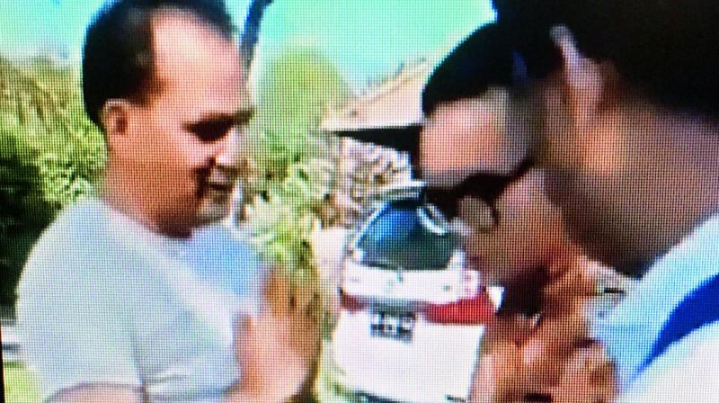 The man appears to be apologising. The man appears to be apologising.