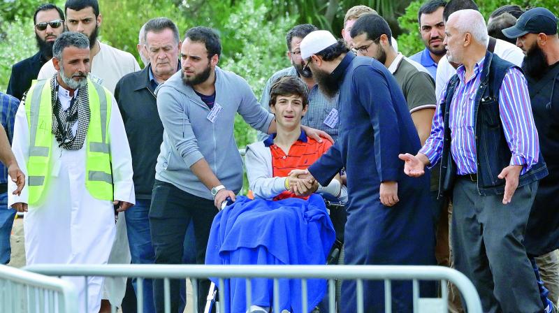 Zaid Mustafa (in wheelchair), who was wounded in the attack on mosques, arrives to attend the funeral of his slain father Khalid Mustafa and brother Hamza Mustafa at the Memorial Park cemetery in Christchurch on Wednesday. — AFP Zaid Mustafa (in wheelchair), who was wounded in the attack on mosques, arrives to attend the funeral of his slain father Khalid Mustafa and brother Hamza Mustafa at the Memorial Park cemetery in Christchurch on Wednesday. — AFP