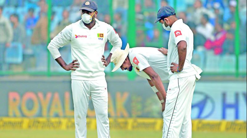 Sri Lanka quick Suranga Lakmal (centre) vomited twice between overs on Tuesday. —PTI Sri Lanka quick Suranga Lakmal (centre) vomited twice between overs on Tuesday. —PTI