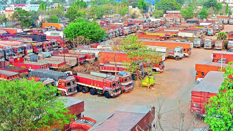 Hundreds of trucks parked at Vanasthalipuram on the fourth day of the strike against excessive tolls on Sunday. Hundreds of trucks parked at Vanasthalipuram on the fourth day of the strike against excessive tolls on Sunday.