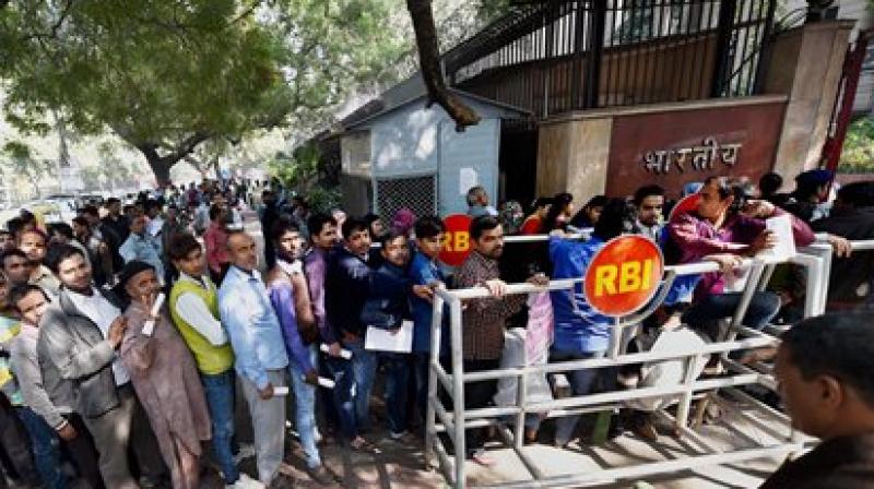 People stand in queue to deposit old bank notes. (Photo: PTI) People stand in queue to deposit old bank notes. (Photo: PTI)