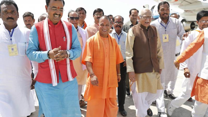 Uttar Pradesh Chief Minister Yogi Adityanath, center, arrives at the Bamrauli airport. (Photo: AP) Uttar Pradesh Chief Minister Yogi Adityanath, center, arrives at the Bamrauli airport. (Photo: AP)