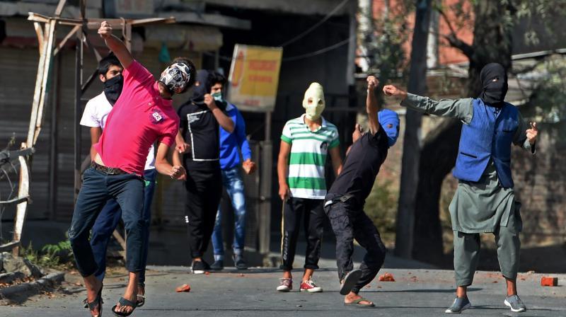 Protesters throw stones at Police and CRPF personnel during a protest after Friday prayers in Srinagar. (Photo: PTI) Protesters throw stones at Police and CRPF personnel during a protest after Friday prayers in Srinagar. (Photo: PTI)