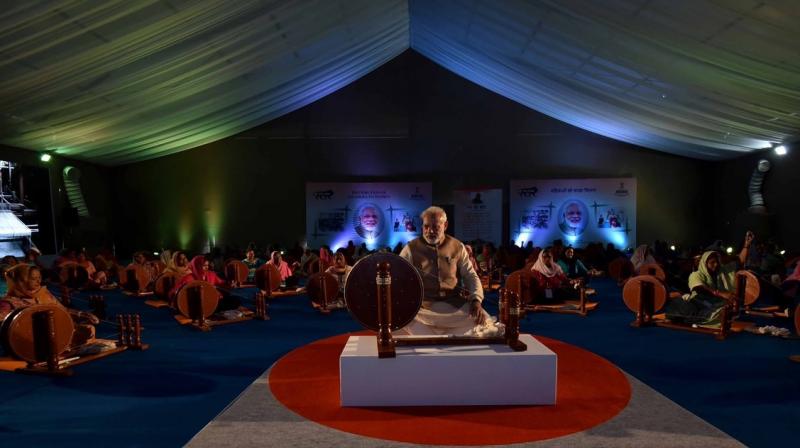 Prime Minister Narendra Modi works at a charkha at a ceremony to distribute charkhas to women before the National MSME Awards at Punjab Agricultural University in Ludhiana. (Photo: PTI) Prime Minister Narendra Modi works at a charkha at a ceremony to distribute charkhas to women before the National MSME Awards at Punjab Agricultural University in Ludhiana. (Photo: PTI)