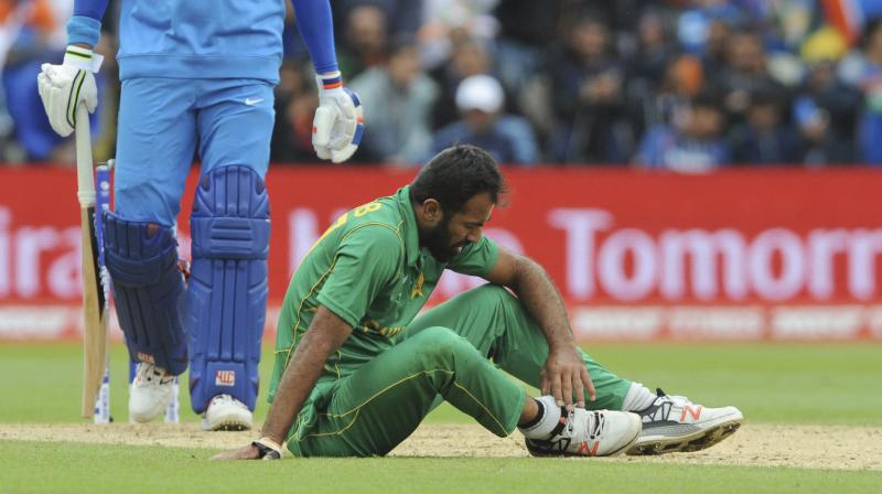 Pakistan's Wahab Riaz sits on the field holding his ankle after an injury during the ICC Champions Trophy match between India and Pakistan at Edgbaston in Birmingham. (Photo: AP) Pakistan's Wahab Riaz sits on the field holding his ankle after an injury during the ICC Champions Trophy match between India and Pakistan at Edgbaston in Birmingham. (Photo: AP)