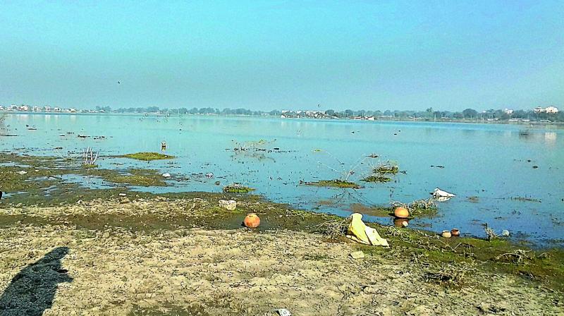 The lake shore has been littered and turned dirty with people throwing garbage including plastic bags and resorting to open defecation and consuming liquor. The lake shore has been littered and turned dirty with people throwing garbage including plastic bags and resorting to open defecation and consuming liquor.