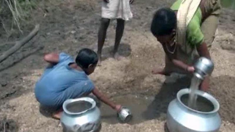 Villagers dig out almost blackened water and use it for their daily chores like cooking, washing and drinking. (Photo: ANI) Villagers dig out almost blackened water and use it for their daily chores like cooking, washing and drinking. (Photo: ANI)