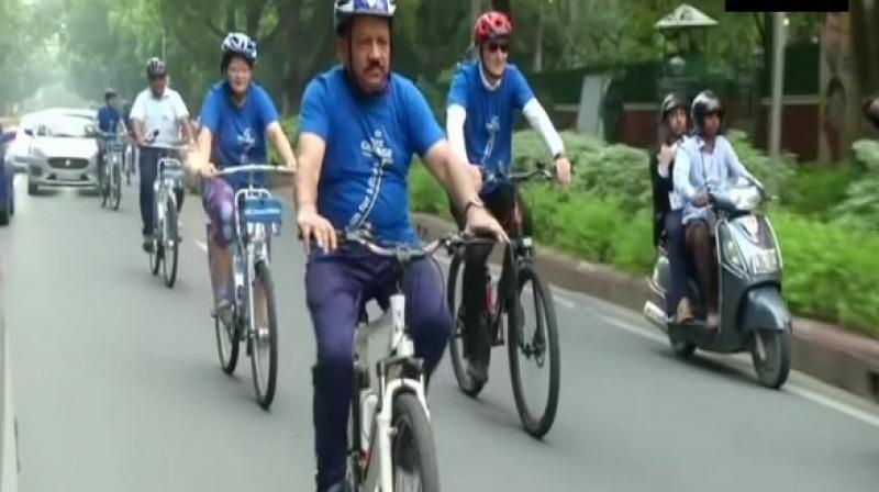 Union Minister Vardhan cycled from his residence at Tees January Marg to the venue of WHO SEARO health minister's meet at New Delhi's Bhikaji Cama Place. (Photo: ANI) Union Minister Vardhan cycled from his residence at Tees January Marg to the venue of WHO SEARO health minister's meet at New Delhi's Bhikaji Cama Place. (Photo: ANI)
