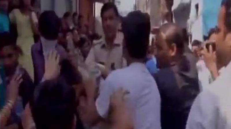 A huge crowd of protesters had converged on the spot after which the cow vigilantes started thrashing those slaughtering the buffalo. (Photo: ANI) A huge crowd of protesters had converged on the spot after which the cow vigilantes started thrashing those slaughtering the buffalo. (Photo: ANI)