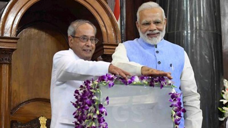 President Pranab Mukherjee and Prime Minister Narendra Modi press buttons for the launch of 'Goods and Services Tax (GST)' at midnight, at the special ceremony in the Central Hall of Parliament in New Delhi on Saturday. (Photo: PTI) President Pranab Mukherjee and Prime Minister Narendra Modi press buttons for the launch of 'Goods and Services Tax (GST)' at midnight, at the special ceremony in the Central Hall of Parliament in New Delhi on Saturday. (Photo: PTI)