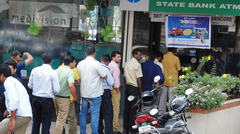 People queue up outside an ATM in Kochi. (Photo: DC) People queue up outside an ATM in Kochi. (Photo: DC)