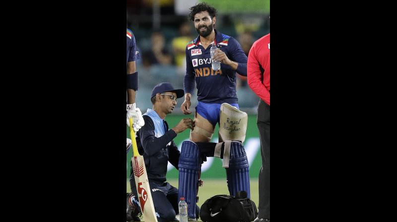 India's Ravindra Jadeja (center) has a trainer tend to his leg during a break in batting against Australia during their T20 international cricket match at Manuka Oval, in Canberra, Australia, on Friday. AP India's Ravindra Jadeja (center) has a trainer tend to his leg during a break in batting against Australia during their T20 international cricket match at Manuka Oval, in Canberra, Australia, on Friday. AP