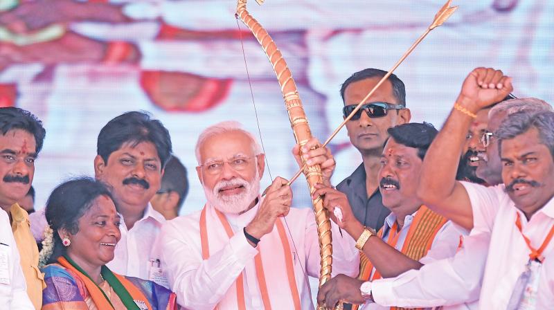 Prime Minister Narendra Modi being presented a bow and an arrow during an election campaign rally in Ramanathapuram, on Saturday. (PTI) Prime Minister Narendra Modi being presented a bow and an arrow during an election campaign rally in Ramanathapuram, on Saturday. (PTI)