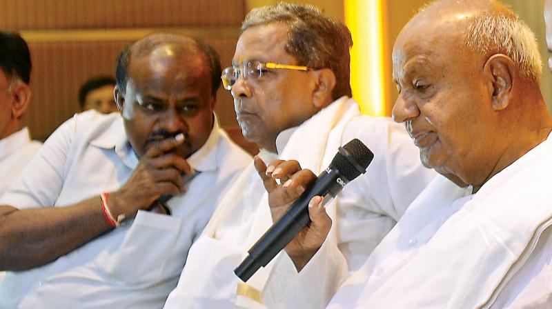 CM H.D. Kumaraswamy has a word with former CM Siddaramaiah even as former PM H.D. Deve Gowda speaks at Congress-JD(S) press meet in Bengaluru on Saturday. (Sathish B.) CM H.D. Kumaraswamy has a word with former CM Siddaramaiah even as former PM H.D. Deve Gowda speaks at Congress-JD(S) press meet in Bengaluru on Saturday. (Sathish B.)