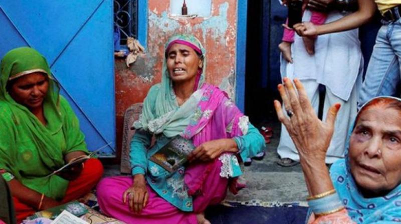 The family of Ikhlaq, who was beaten to death by a mob, at Bishada in Dadri. (Photo: PTI | File) The family of Ikhlaq, who was beaten to death by a mob, at Bishada in Dadri. (Photo: PTI | File)