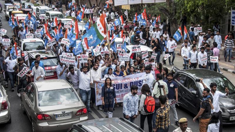 NSUI and DUSU activists display placards and shout slogans during a protest march against rape cases, atrocities against women and various other issues, in North Campus, Delhi University (Photo: PTI) NSUI and DUSU activists display placards and shout slogans during a protest march against rape cases, atrocities against women and various other issues, in North Campus, Delhi University (Photo: PTI)