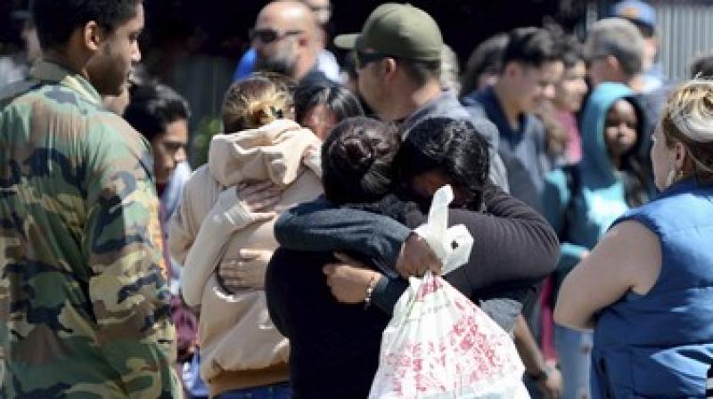 Students are reunited with family members outside Highland High School in Palmdale, California. (Photo: AP) Students are reunited with family members outside Highland High School in Palmdale, California. (Photo: AP)