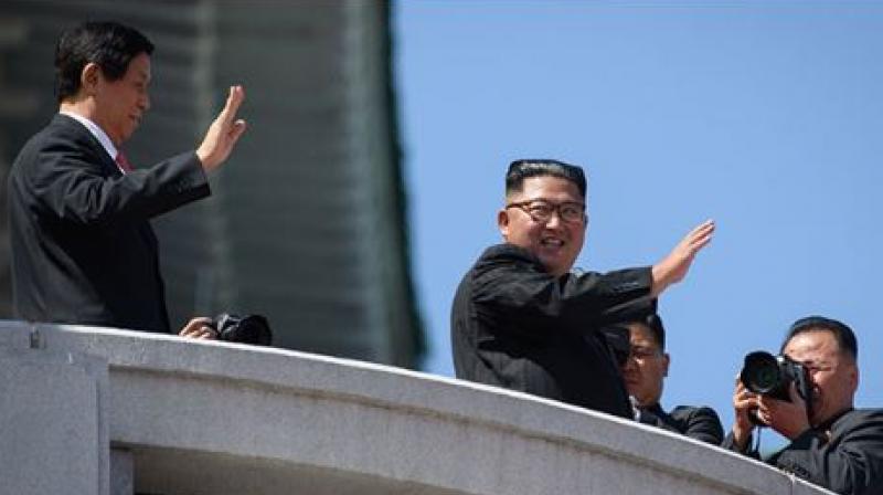 Kim Jong Un showed off his friendship with China, raising the hand of President Xi Jinping's envoy as they saluted the crowd together afterwards (Photo: AFP) Kim Jong Un showed off his friendship with China, raising the hand of President Xi Jinping's envoy as they saluted the crowd together afterwards (Photo: AFP)