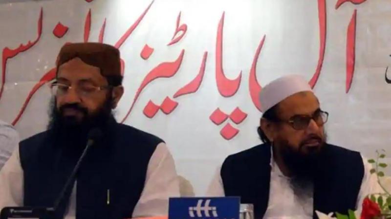 Hafiz Saeed (right) and Pakistan’s religious affairs minister Noor-Ul-Haq Qadri were seen together at an event in Islamabad.(Photo: Twitter | @NadeemAwan_) Hafiz Saeed (right) and Pakistan’s religious affairs minister Noor-Ul-Haq Qadri were seen together at an event in Islamabad.(Photo: Twitter | @NadeemAwan_)
