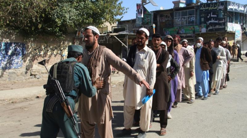 An Afghan policeman searches voters before casting their votes, with many voters having to queue for hours. (Photo: AFP) An Afghan policeman searches voters before casting their votes, with many voters having to queue for hours. (Photo: AFP)