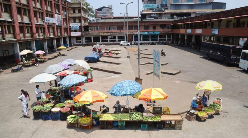 Vendors selling vegetables at a deserted Kozhikode bus stand. (PTI)