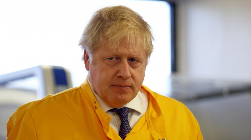 Britains Prime Minister Boris Johnson visits a laboratory at the Public Health England National Infection Service in London. AFP Photo