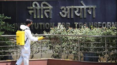 A health worker sanitises the premises of NITI Aayog building in New Delhi. (PTI)